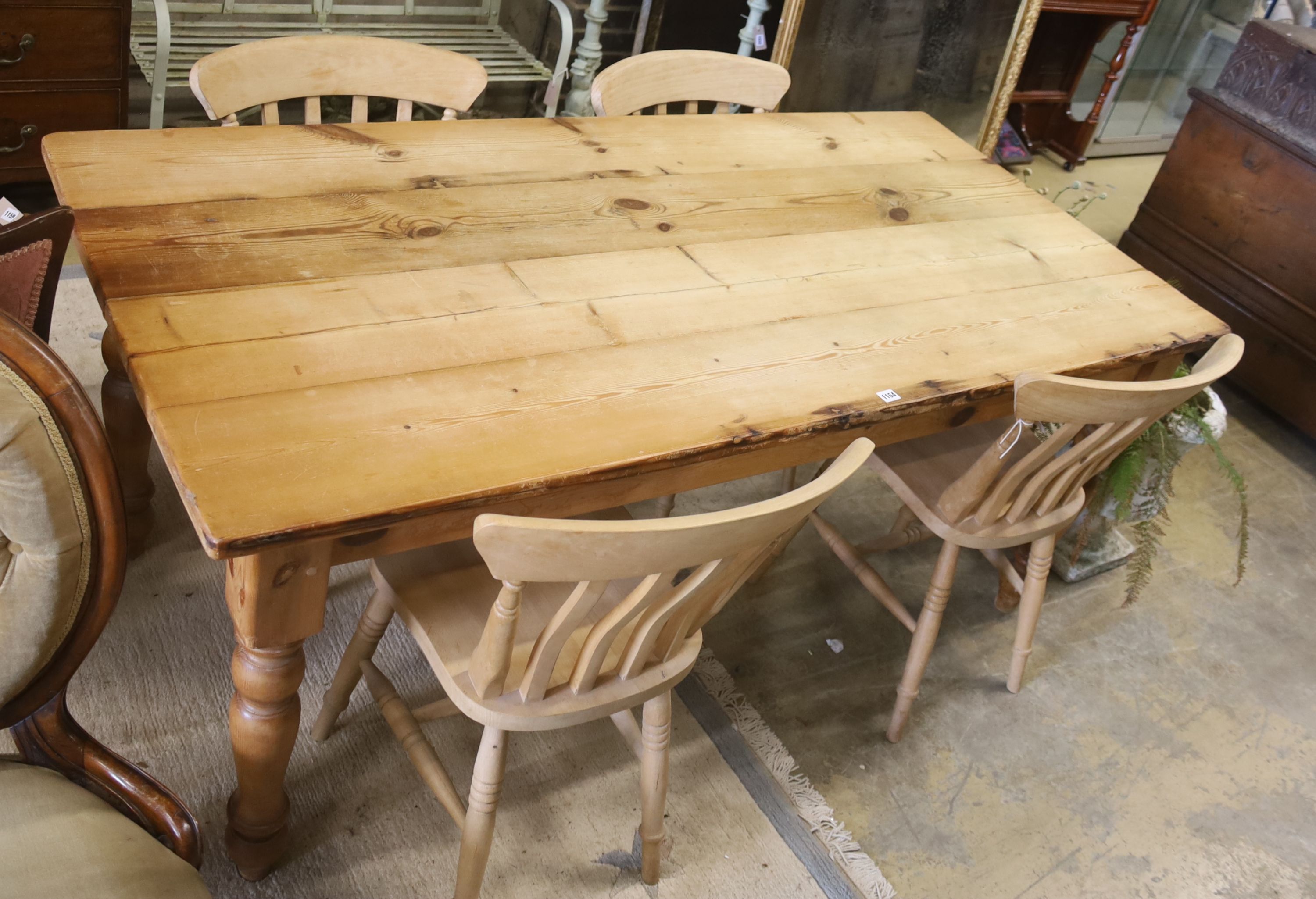 A pine 'farmhouse' kitchen table, length 183cm, depth 87cm, height 78cm fitted single end drawer and a set of four Windsor beech chairs